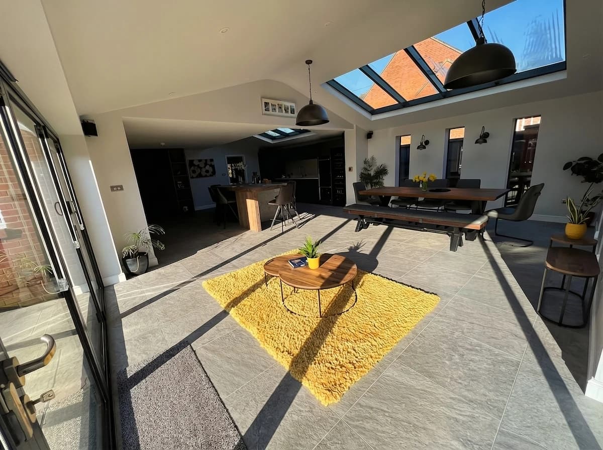 Wide view of the completed open-plan kitchen extension with skylights and bifold doors